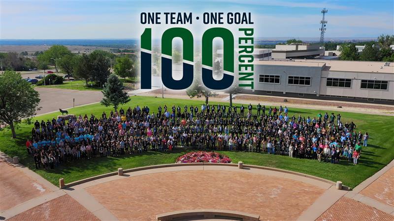 Photo of goal staff with the word One Team One Goal 100%